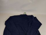 a blue sweater sitting on top of a white table