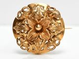 a close up of a gold ring with a flower on it