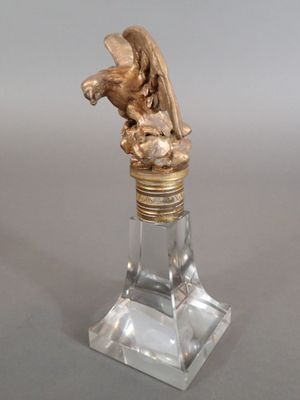 a statue of an angel on top of a glass bottle