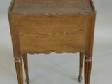 a small wooden table with a drawer on top of it