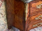 a marble top chest of drawers on a rug
