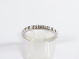 a close up of a silver ring on a white surface