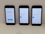 four cell phones are lined up on a table with a white background
