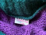close up of a purple and teal scarf with a label on it