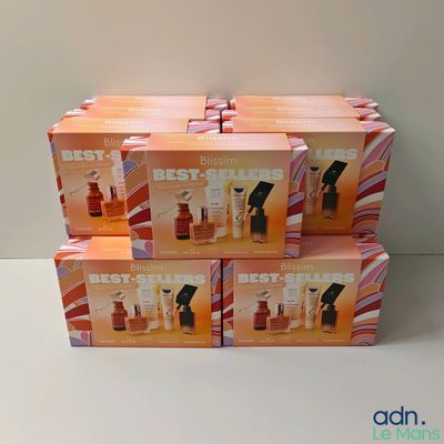 four boxes of best sellers perfume sitting on top of a white table