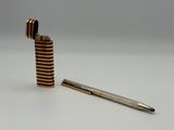 a close up of a lighter and a pen on a table