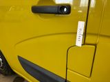 a close up of a door handle on a yellow van
