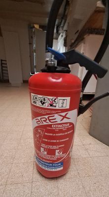 a fire extinguisor sitting on the floor in a room