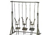 a metal swing set with four swings attached to it