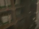 a blurry photo of a room with a shelf full of boxes