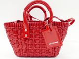 the small red basket bag has a tag attached to it