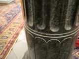 a black pillar with a decorative design on it