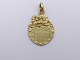 a gold medal with the words, ' i am proud to be a woman '