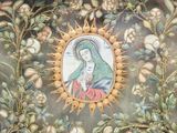 a picture of a picture of the virgin mary on the wall