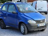 une petite voiture bleue garée dans un parking