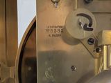 a close up of a clock that is on a table