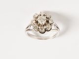 a close up of a diamond ring on a white surface