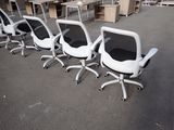 several office chairs are lined up in a row in an empty room