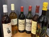 several bottles of wine sitting on top of a wooden table
