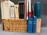 several books are stacked on top of each other on a table