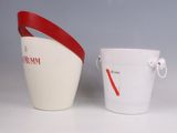 a white bucket with a red handle next to a white bucket with a red handle