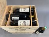 bottles of wine are in a wooden box on a table