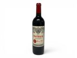 a bottle of red wine sitting on top of a white table