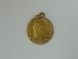 a close up of a gold coin on a white surface