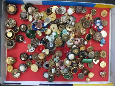 une boîte remplie de boutons assortis posée sur un fond rouge