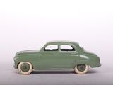 a green toy car that is sitting on a table