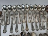 a lot of silver spoons and spoon spoons on a table