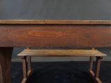 a wooden desk with a bench in front of it