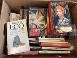 many books in a box that are sitting on top of each other