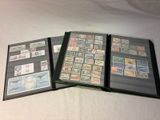 several different types of stamps in a folder on a white surface