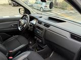 the interior of a car with the door open and the driver ' s seat down