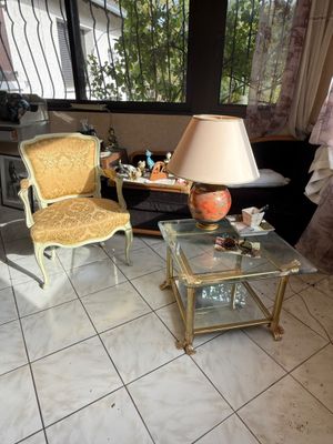 two chairs and a table with a lamp on it