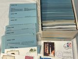 a box with a lot of postcards on a table