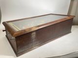 a wooden box with a glass top on a table