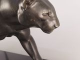 bronze sculpture of a panther on a black marble base