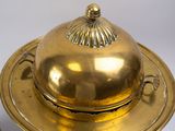 a gold plate with a dome on top of it
