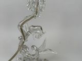 a glass lamp that has a flower on top of it