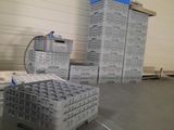 a stack of plastic containers sitting on the floor in a warehouse