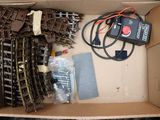 a box with a bunch of train tracks and wires in it