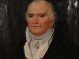 portrait d'un homme en manteau noir et chemise blanche