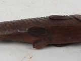 wooden fish figurine sitting on a table with a white background