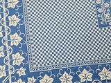 a close up of a blue and white rug with a checkered design