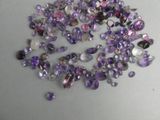 purple amethorate and white topazte beads on a table