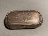 an old silver box sitting on top of a table
