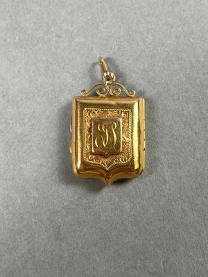 Médaillon porte-photos en or jaune (750/00) délicatement cis…