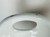 a white vase with a hole in the middle of it